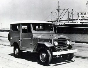 A black and white photo of an old jeep.