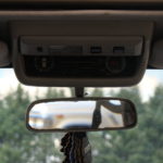 A rear view mirror of the inside of a car.