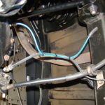 A blue wire is connected to the wires on the side of the vehicle.