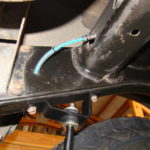 A blue wire is connected to the front of the car.