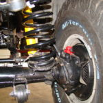 A close up of the front suspension on an off road vehicle.
