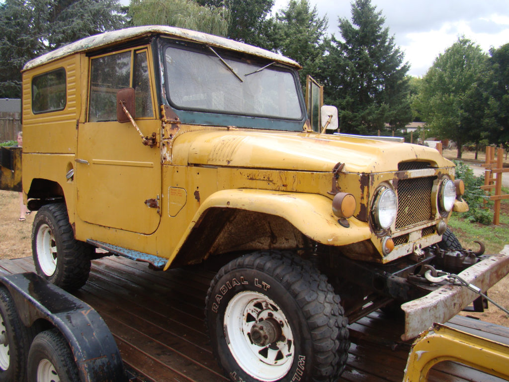 A yellow truck is parked on the trailer.