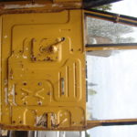 A yellow door of an old truck.