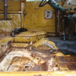 A close up of the inside of an old yellow truck.