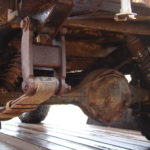 A close up of the front wheel on an old truck