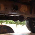 A close up of the underside of an old truck.