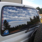 A truck with its rear window open and the back of it.