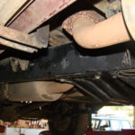 A close up of the underside of an old truck.