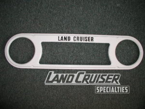 A white metal object with the words land cruiser written on it.