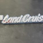 A car emblem that says land cruise