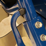 A close up of the handle on a blue chair.
